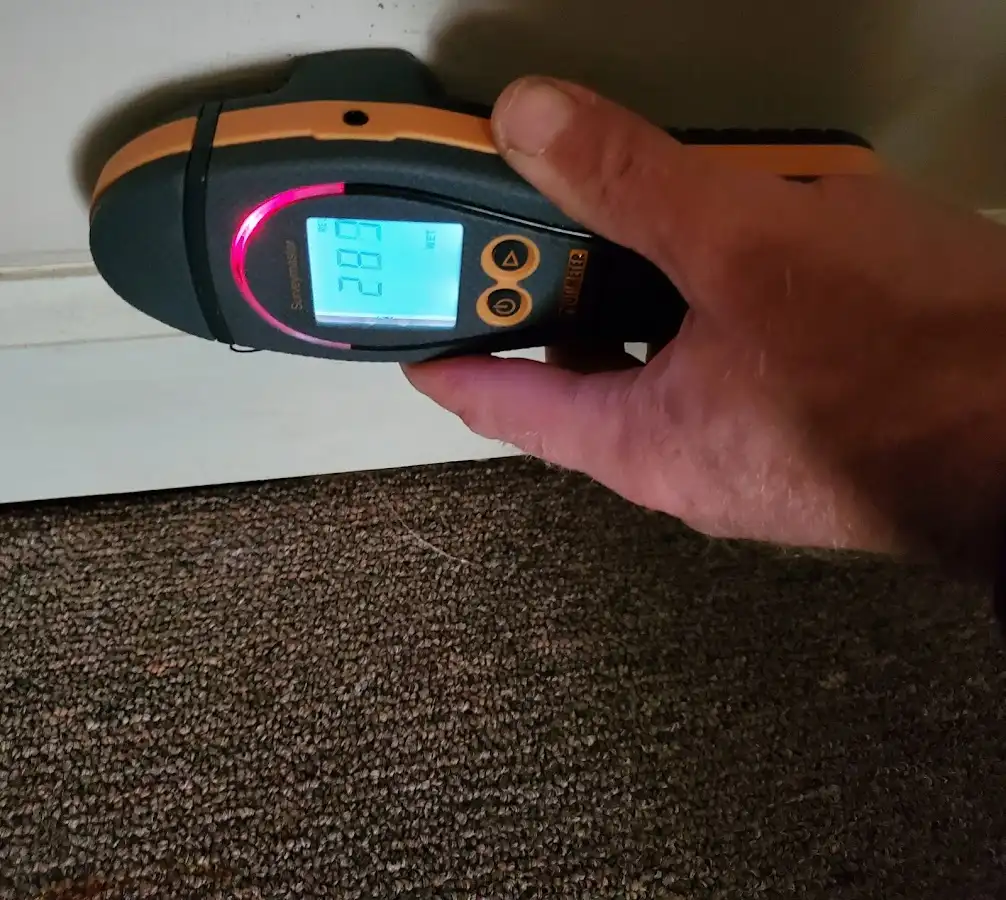 Moisture detection at baseboard during Storm Damage Restoration in Wildwood